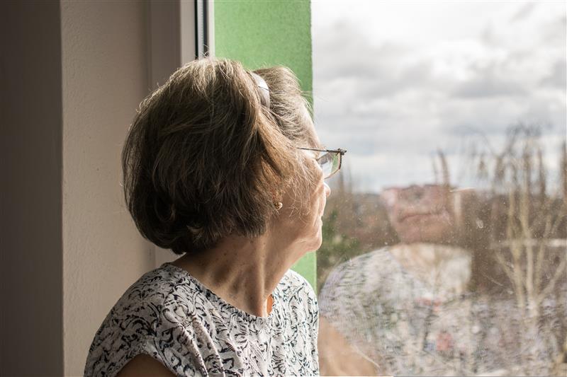 Care home outdoor pathway cleared of snow and ice, with handrails and grit applied for winter safety, ensuring safe mobility for older residents.