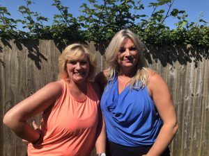 two fitness instructors smiling in the garden