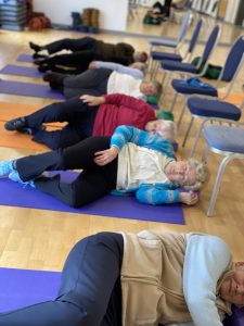 People with balance problems lying on the floor during an exercise class