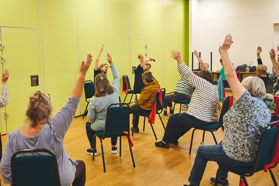 Seated participants doing stretching and seated exercise for an iCareiMove falls prevention class