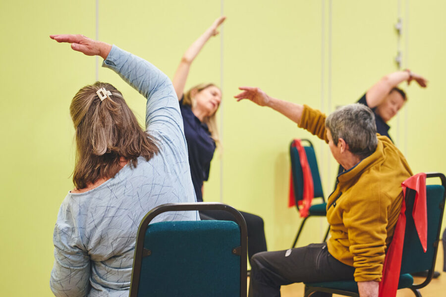Seated participants doing stretching and seated exercise for an iCareiMove falls prevention class