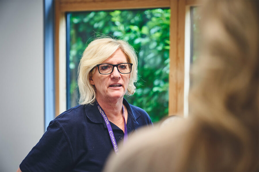 Pat Taylor of iCareiMove talking to a colleague at an iCareiMove event in Cornwall.