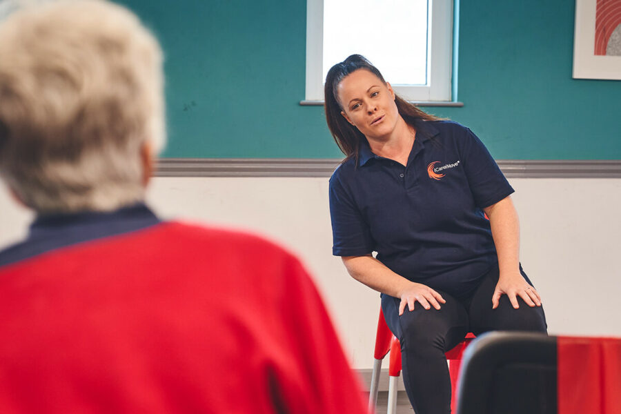 An iCareiMove Falls Prevention instructor leads a gentle exercise group session.